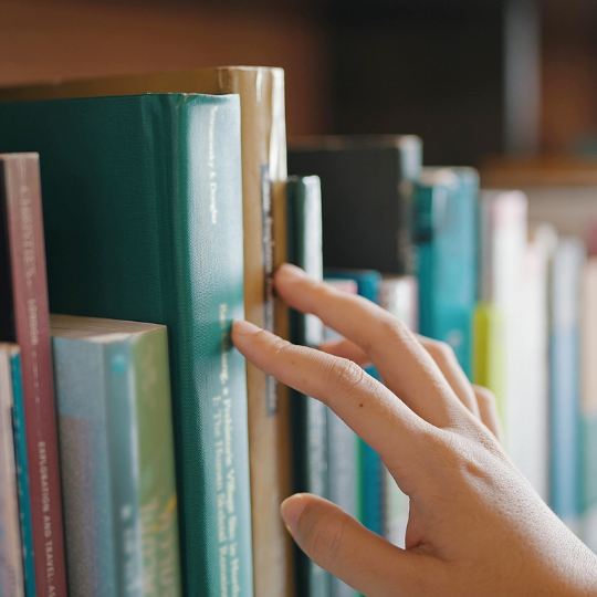 Looking through library book shelves